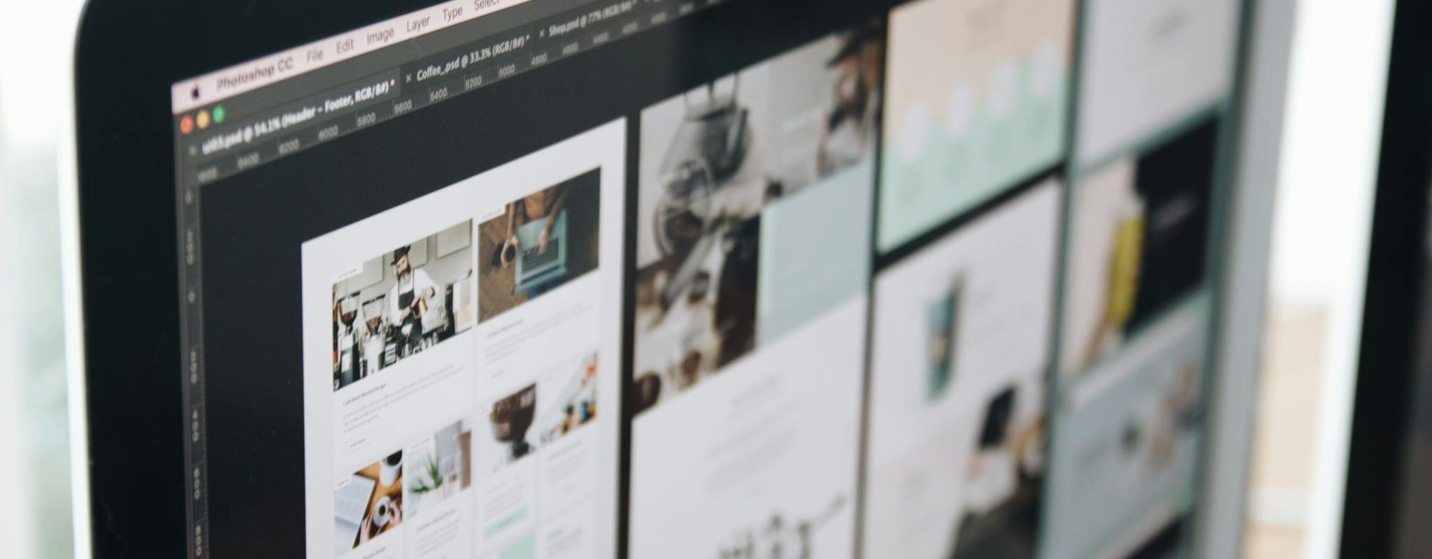 A modern computer screen displaying web design work, showcasing creative visuals in a workspace.