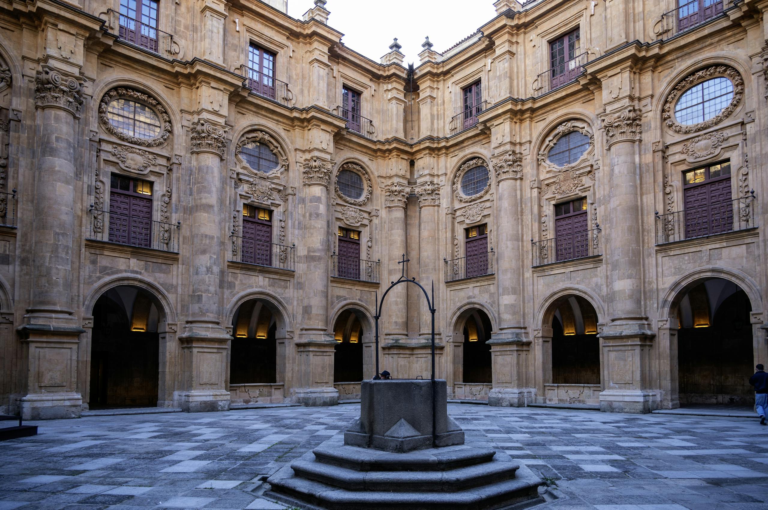 Beautiful stone courtyard of Universidad de Salamanca, showcasing intricate Renaissance architecture.