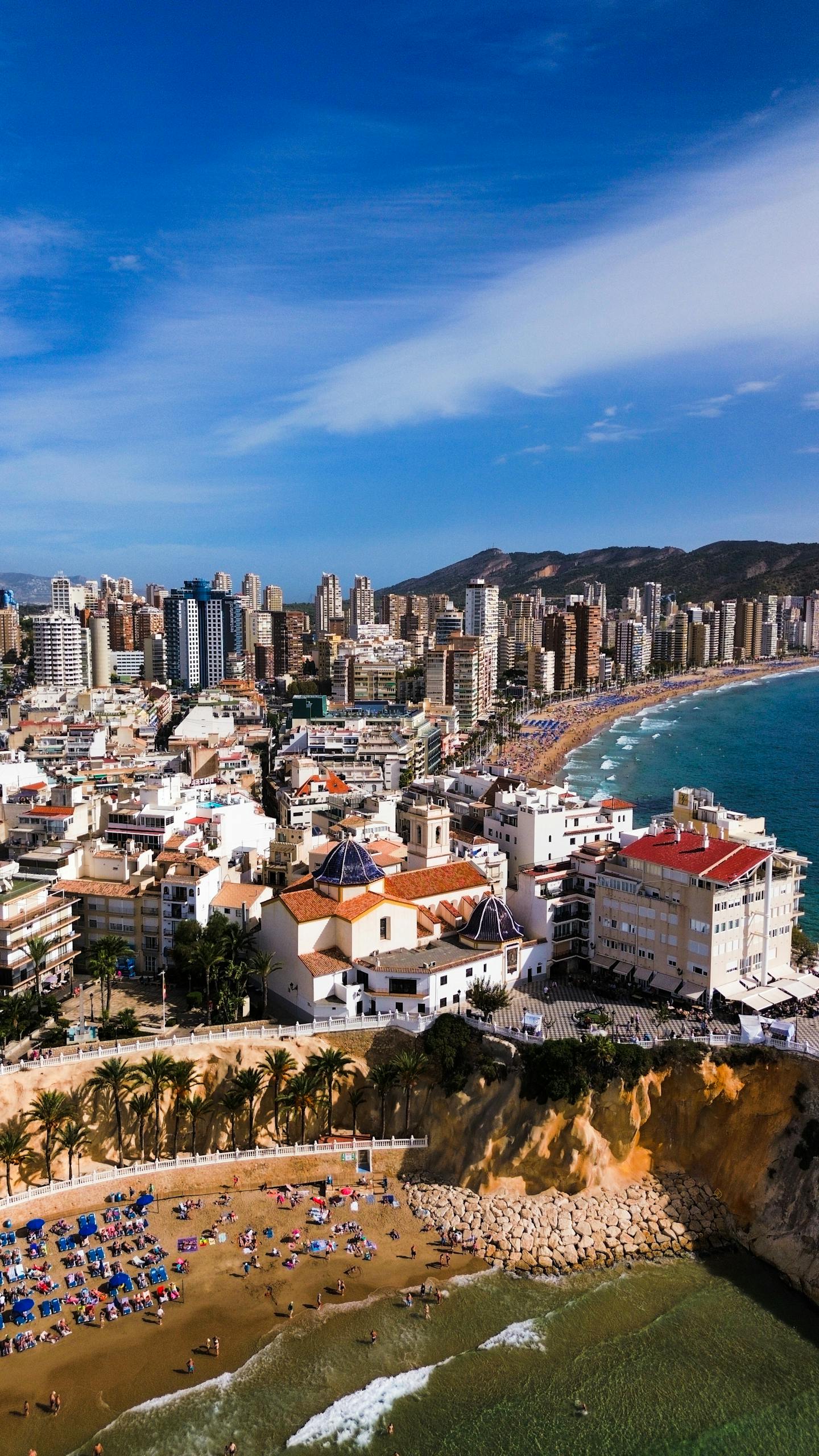 Explore the stunning skyline and sandy beaches of Benidorm, Spain. A vibrant urban landscape meeting the Mediterranean Sea.